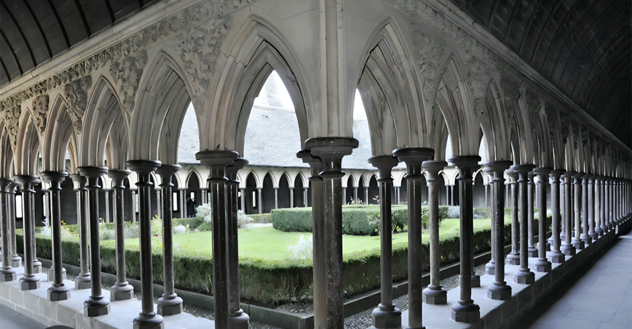 The cloister of Mont Saint-Michel — its double row of slender columns and pointed arches around the garden court.